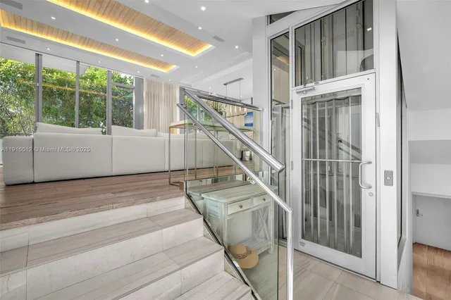 a living room with furniture and large windows
