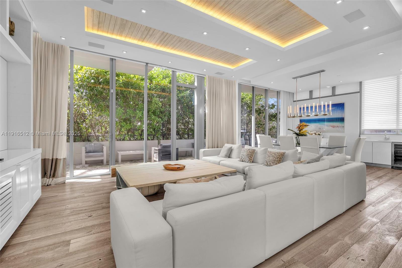 9501 Collins Avenue, Unit 1 Surfside, FL 33154 - Photo 14 of 53 a living room with furniture and large windows