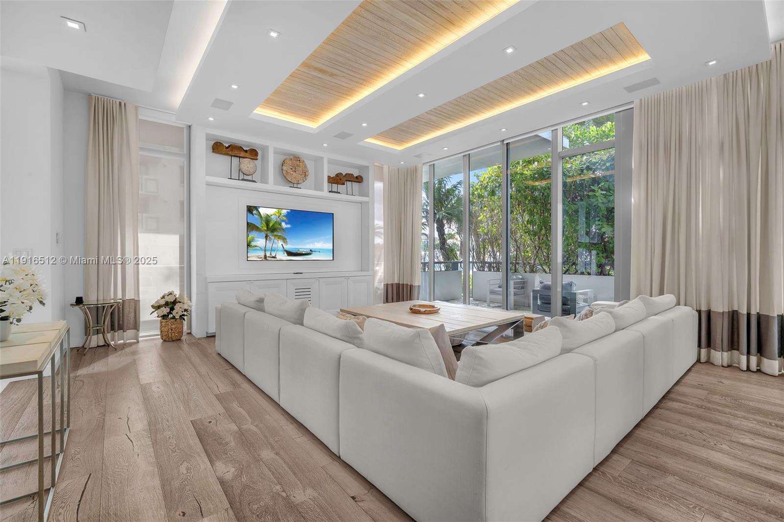 9501 Collins Avenue, Unit 1 Surfside, FL 33154 - Photo 16 of 53 a living room with furniture and a large window