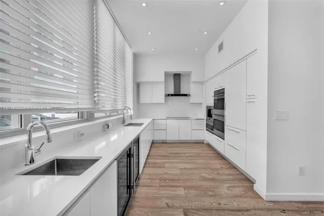 a kitchen with a sink and a refrigerator