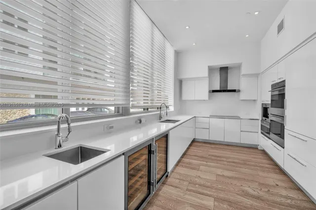 a kitchen with granite countertop a sink and a stove top oven