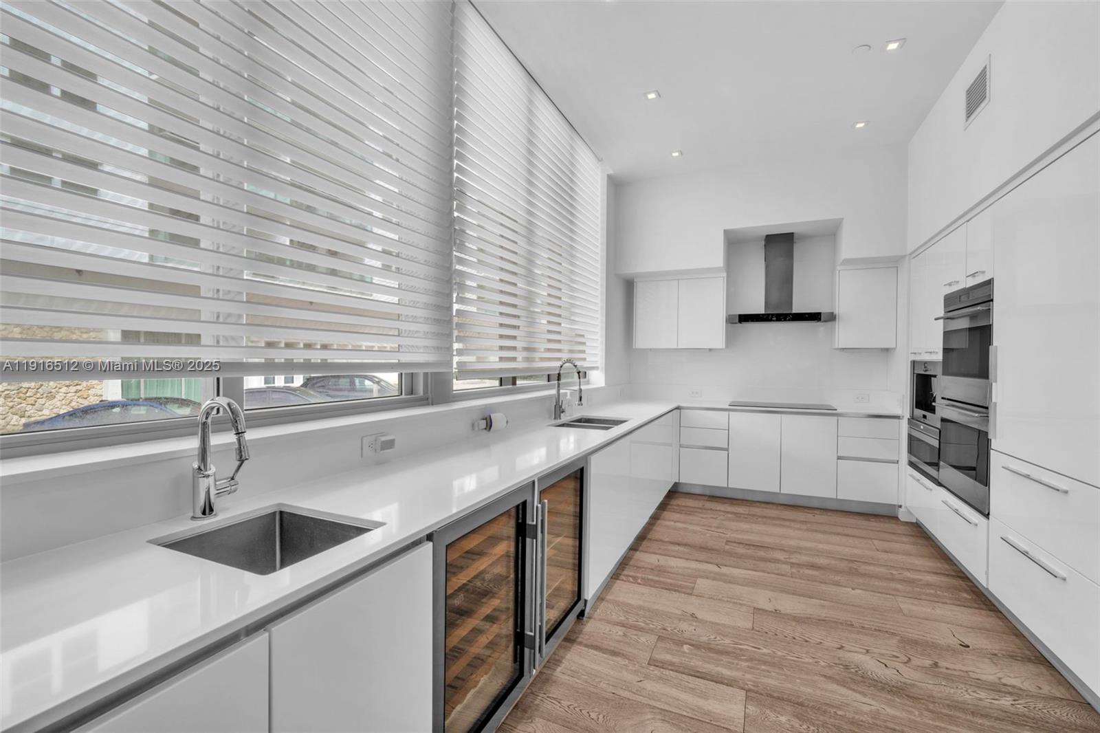 9501 Collins Avenue, Unit 1 Surfside, FL 33154 - Photo 21 of 53 a kitchen with a sink and a refrigerator