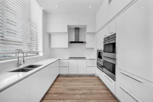 a kitchen with a sink cabinets and window