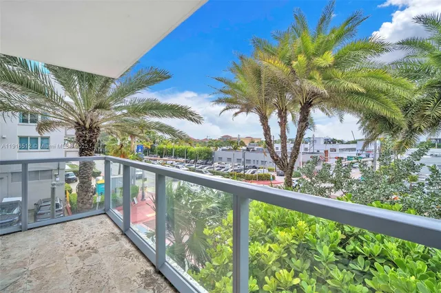 a bedroom with two beds and a painting on the wall
