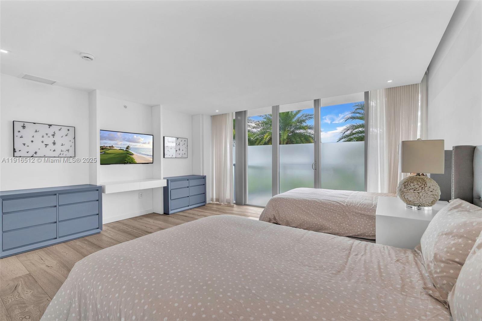 9501 Collins Avenue, Unit 1 Surfside, FL 33154 - Photo 30 of 53 a bedroom with a bed and a dresser