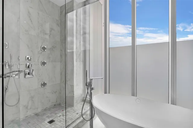 a bathroom with a shower and a glass door