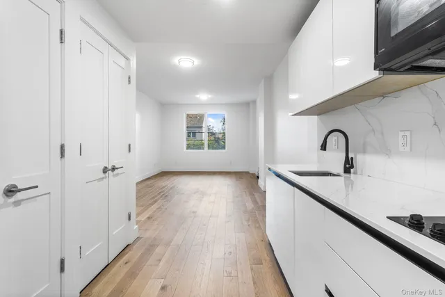 a kitchen with a sink and refrigerator