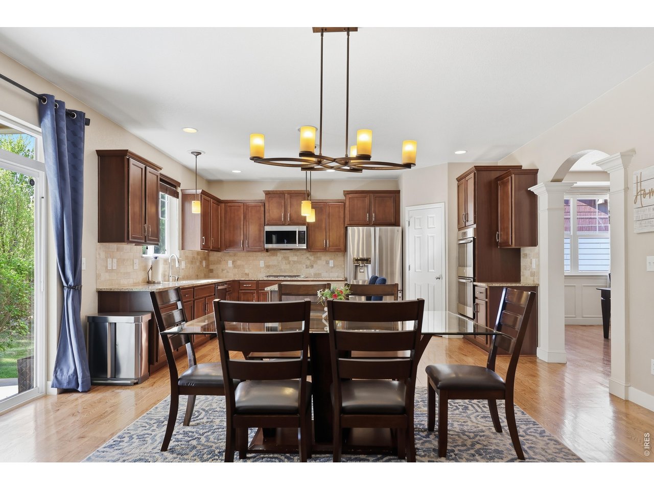 8709 Tack Street Frederick, CO 80504 - Photo 15 of 43 a view of a dining room with furniture and wooden floor