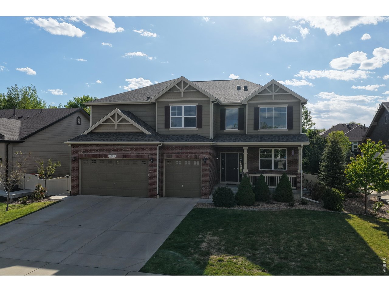 8709 Tack Street Frederick, CO 80504 - Photo 3 of 43 a front view of a house with a garden