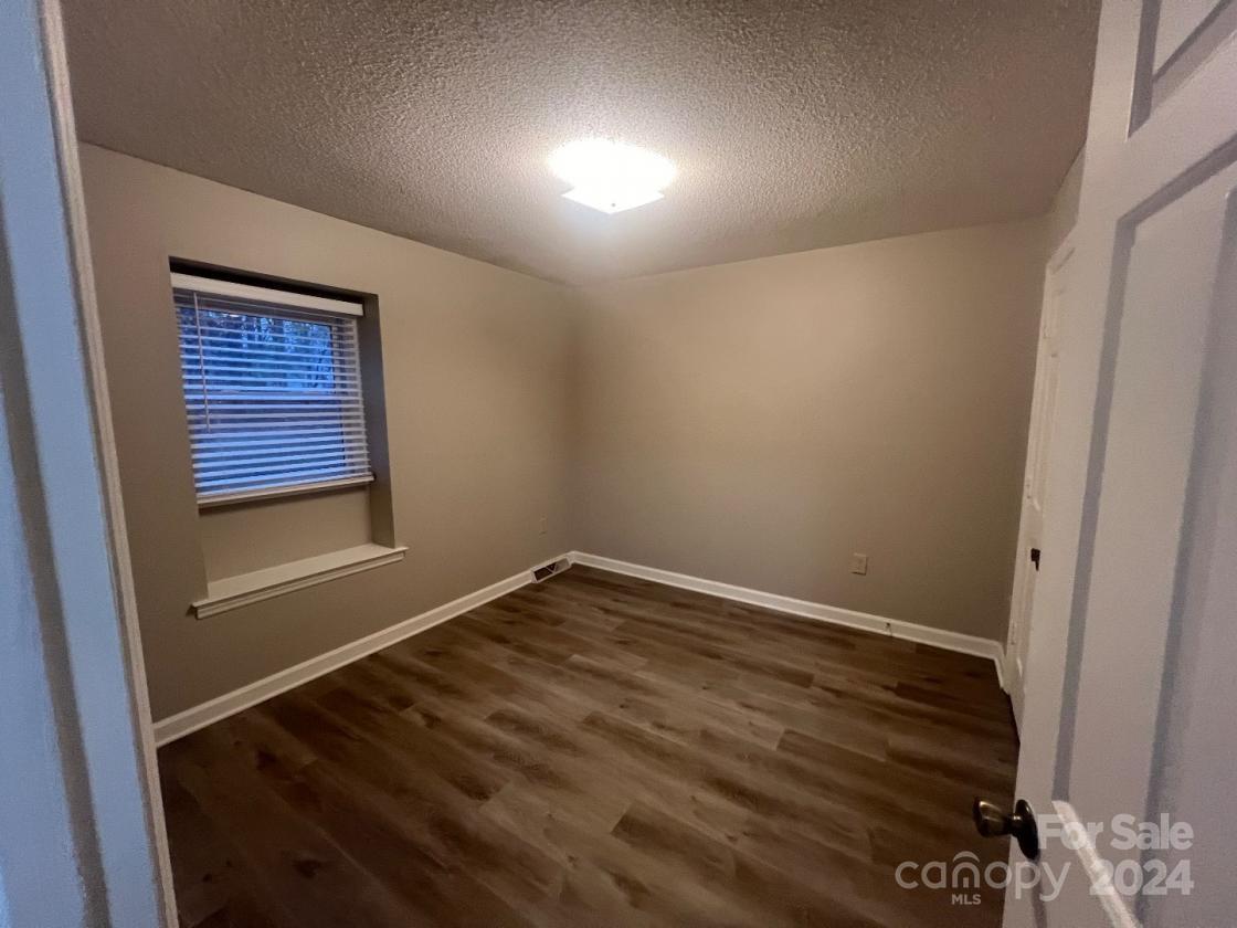 11714 Harrowfield Road Charlotte, NC 28226 - Photo 13 of 15 a view of an empty room and wooden floor