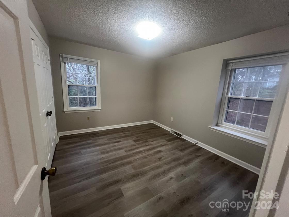 11714 Harrowfield Road Charlotte, NC 28226 - Photo 14 of 15 an empty room with wooden floor and windows