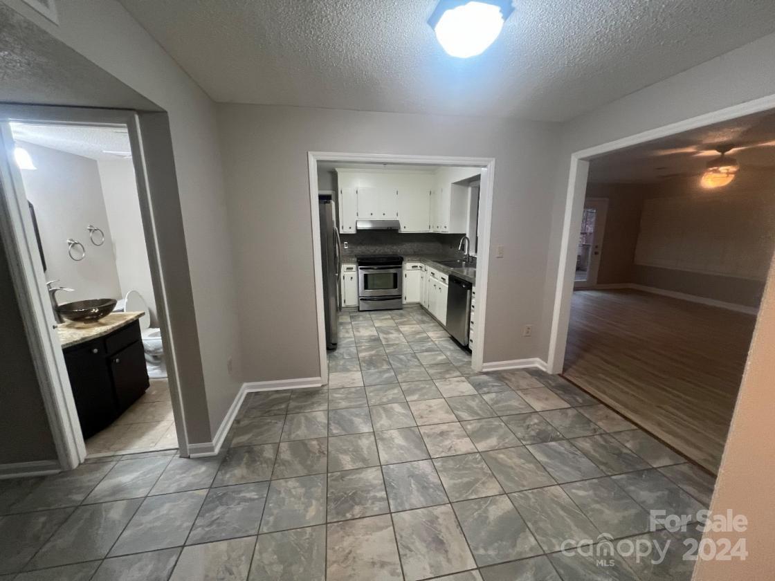 11714 Harrowfield Road Charlotte, NC 28226 - Photo 2 of 15 a view of a refrigerator in kitchen and an empty room