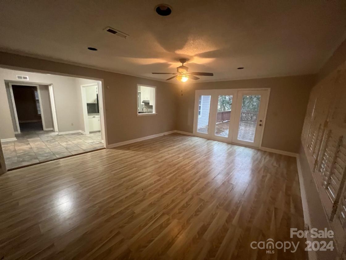 11714 Harrowfield Road Charlotte, NC 28226 - Photo 4 of 15 a view of an empty room with window and wooden floor