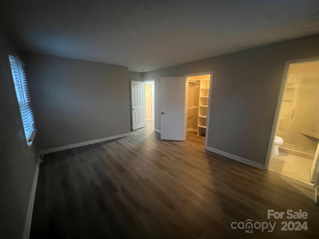 11714 Harrowfield Road Charlotte, NC 28226 - Photo 9 of 15 an empty room with wooden floor and windows