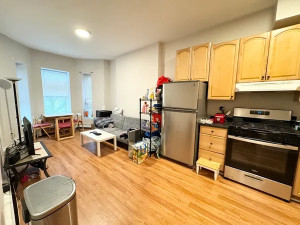 a living room with furniture a flat screen tv and large window
