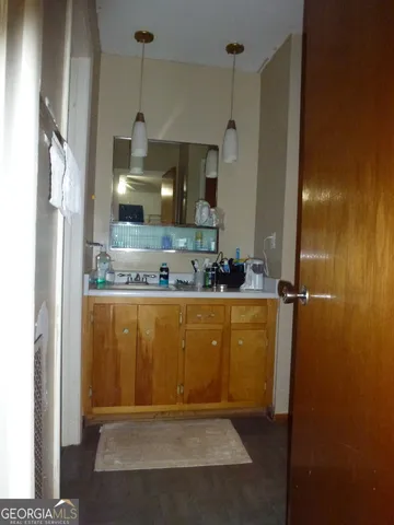 a bathroom with a granite countertop sink mirror and vanity