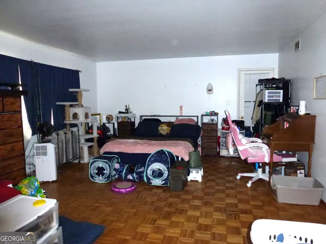 a bedroom with a bed and a couch