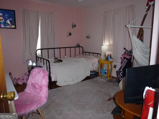 a bed room with a bed and a chair