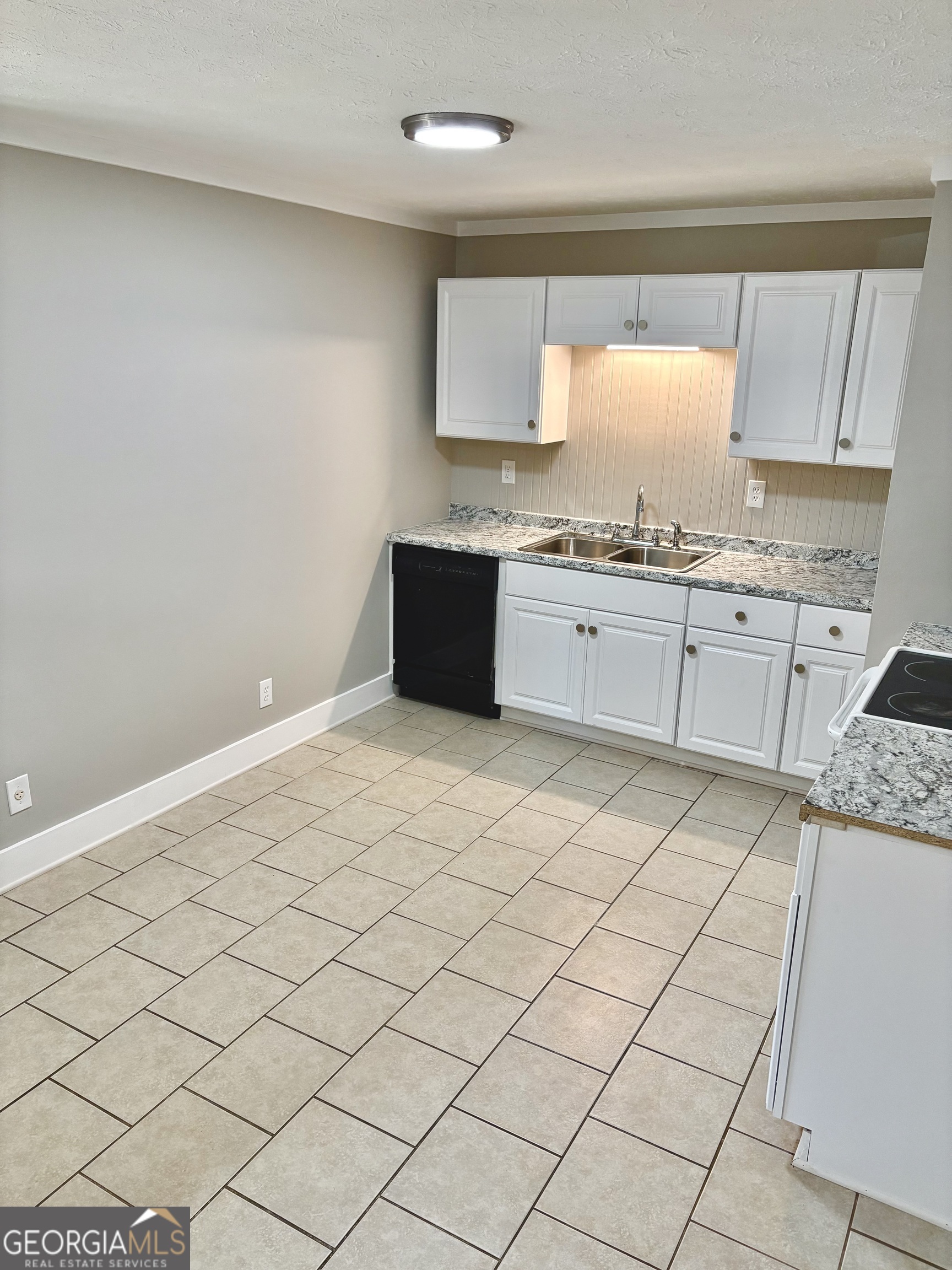 56 John Lovelace Road LaGrange, GA 30241 - Photo 13 of 26 a large kitchen with granite countertop white cabinets and a sink