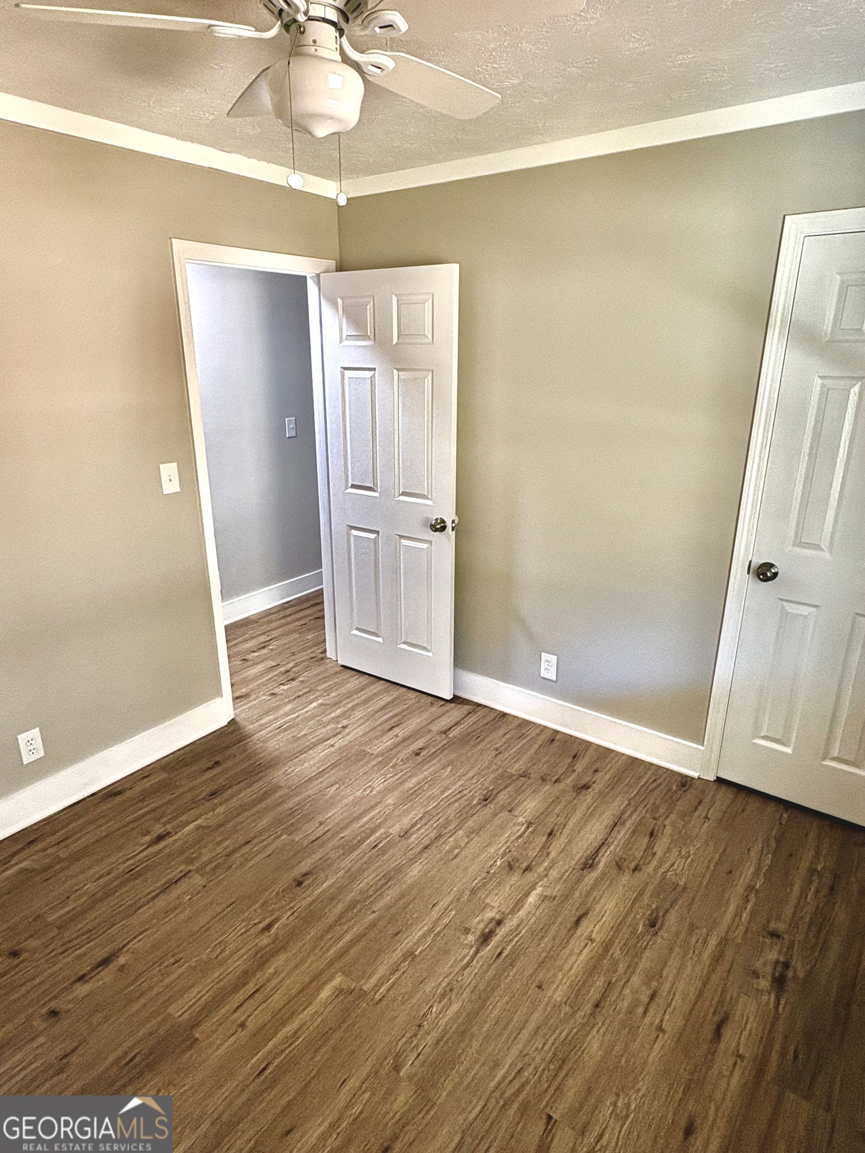 56 John Lovelace Road LaGrange, GA 30241 - Photo 17 of 26 an empty room with wooden floor and ceiling fan