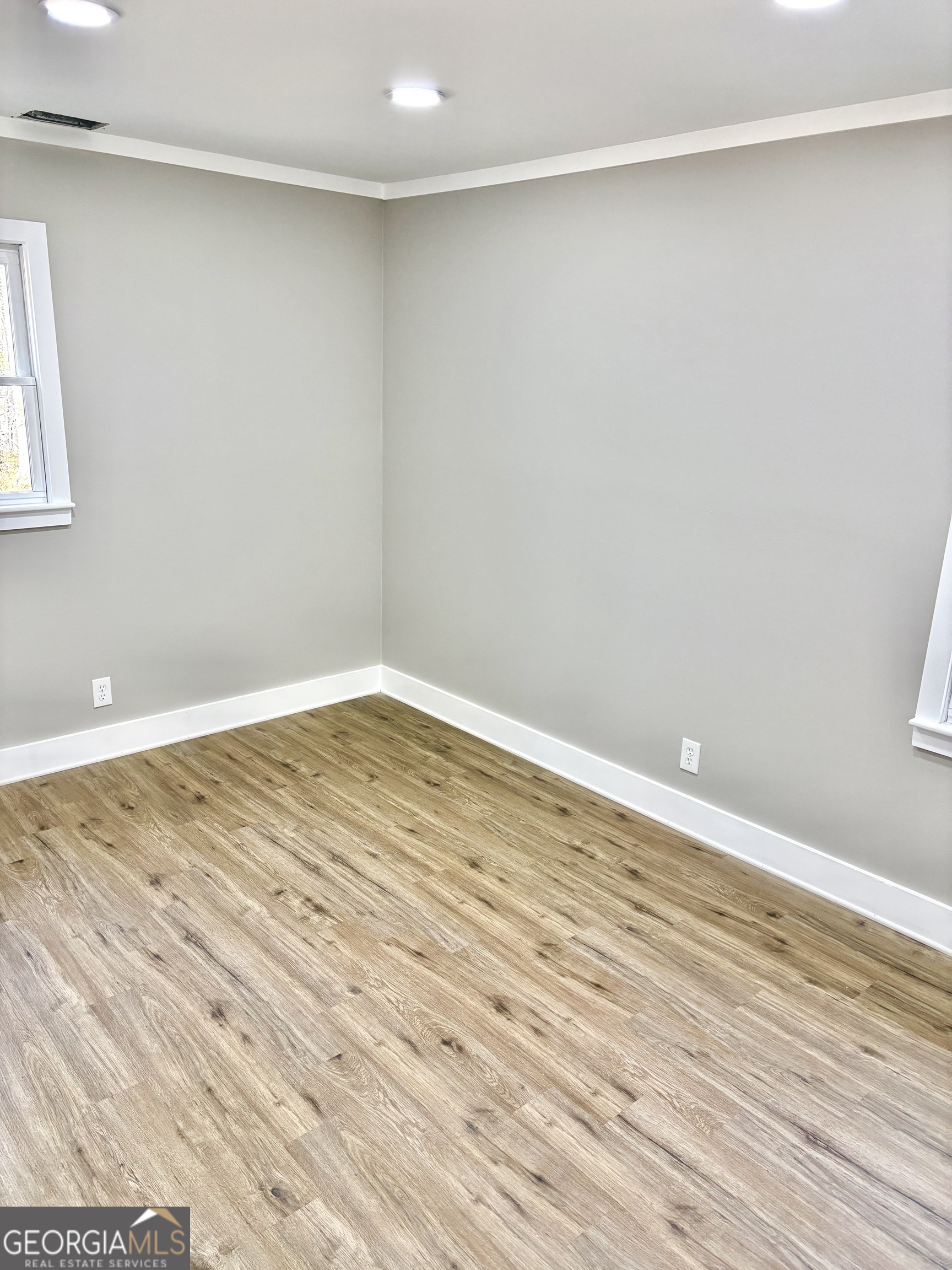 56 John Lovelace Road LaGrange, GA 30241 - Photo 19 of 26 a view of an empty room with wooden floor and a window