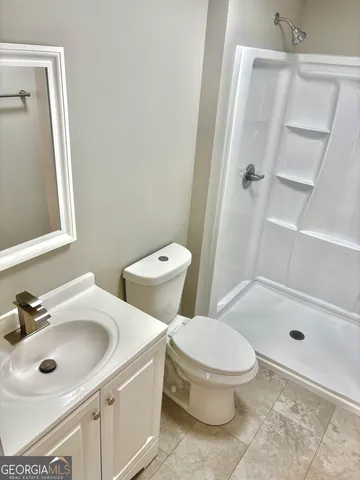 a white toilet sitting next to a bathroom sink