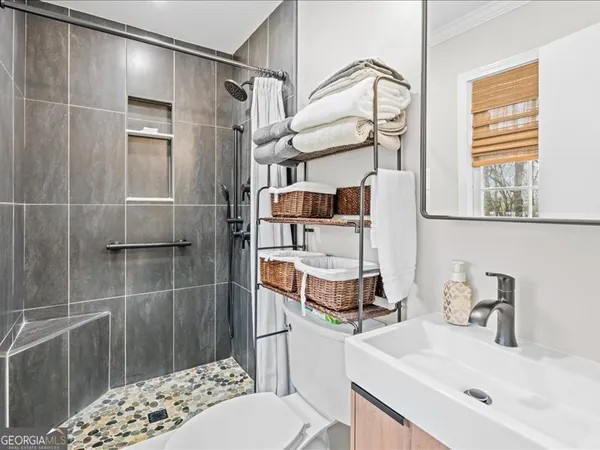 a bathroom with a sink toilet and shower