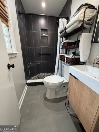 a bathroom with a toilet and a shower