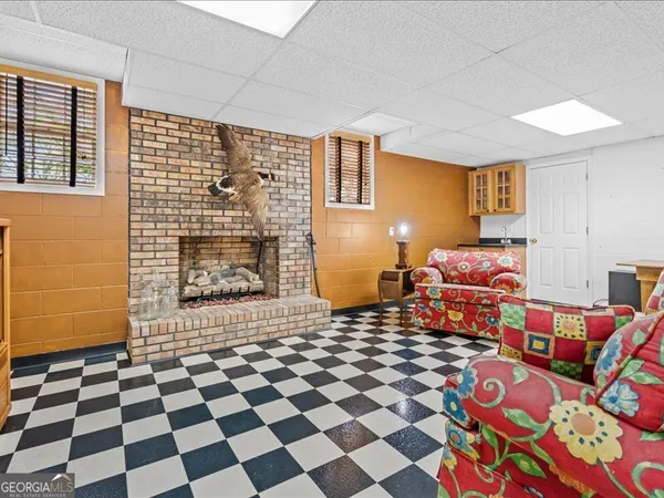 a large bedroom with a bed and wooden floor