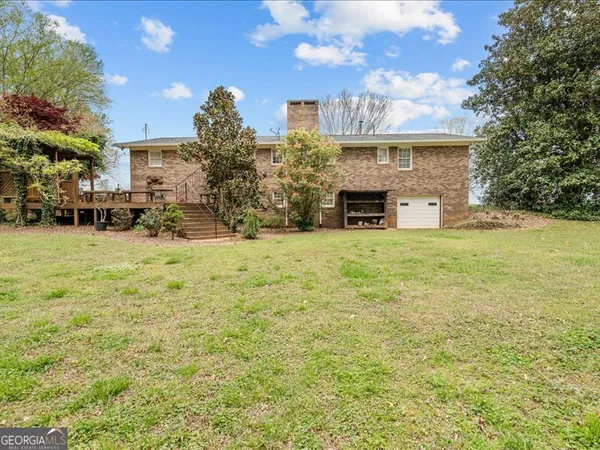 front view of a house with a yard and an trees