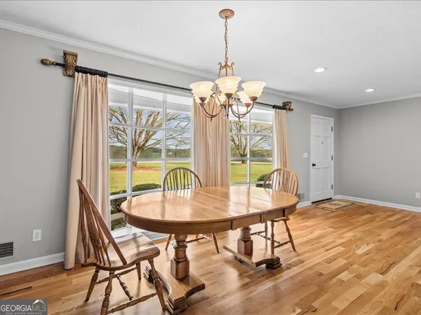 a view of a dining room with furniture window and outside view