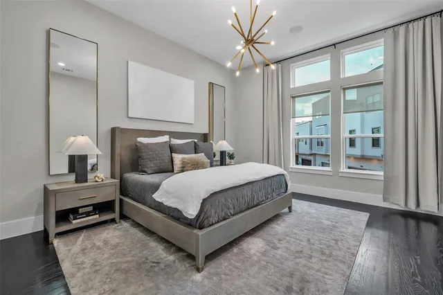 a spacious bedroom with a bed and a large window