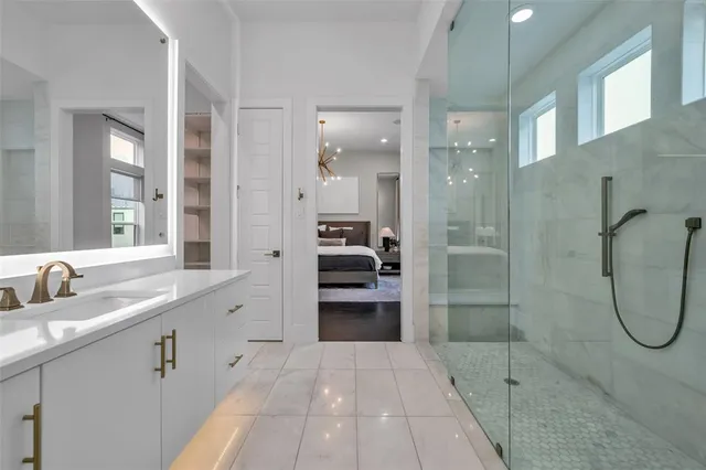 a bathroom with a shower sink and mirror