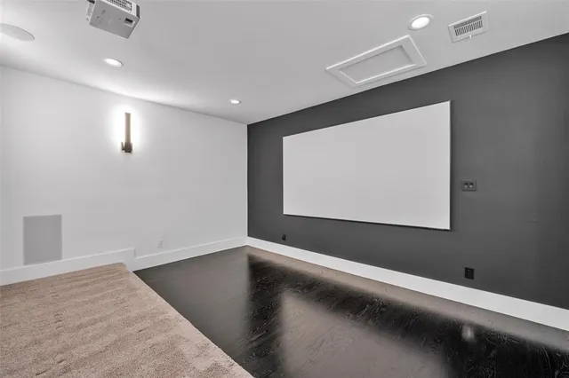 a view of a livingroom with wooden floor and a large window