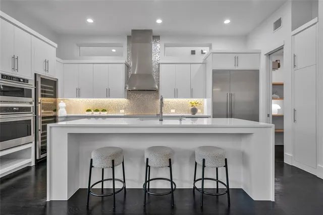 a kitchen with cabinets and stainless steel appliances