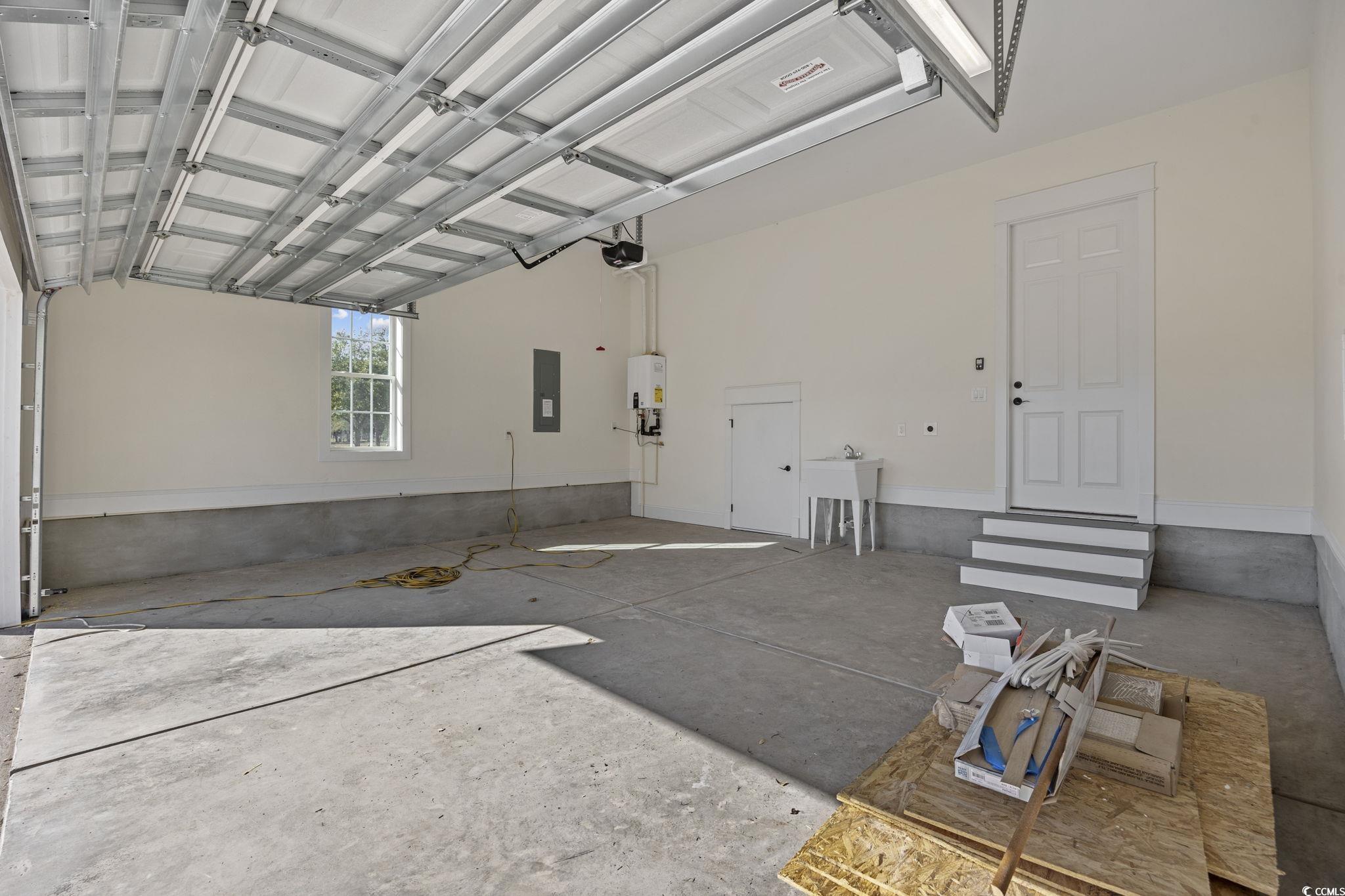 965 Hackler Street, Unit E Myrtle Beach, SC 29577 - Photo 30 of 36 Garage featuring electric panel and water heater