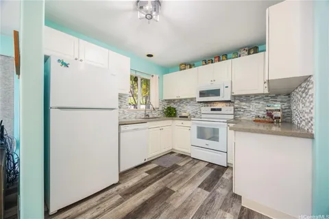a white refrigerator freezer sitting inside of a kitchen