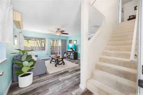 a living room filled with furniture and a potted plant