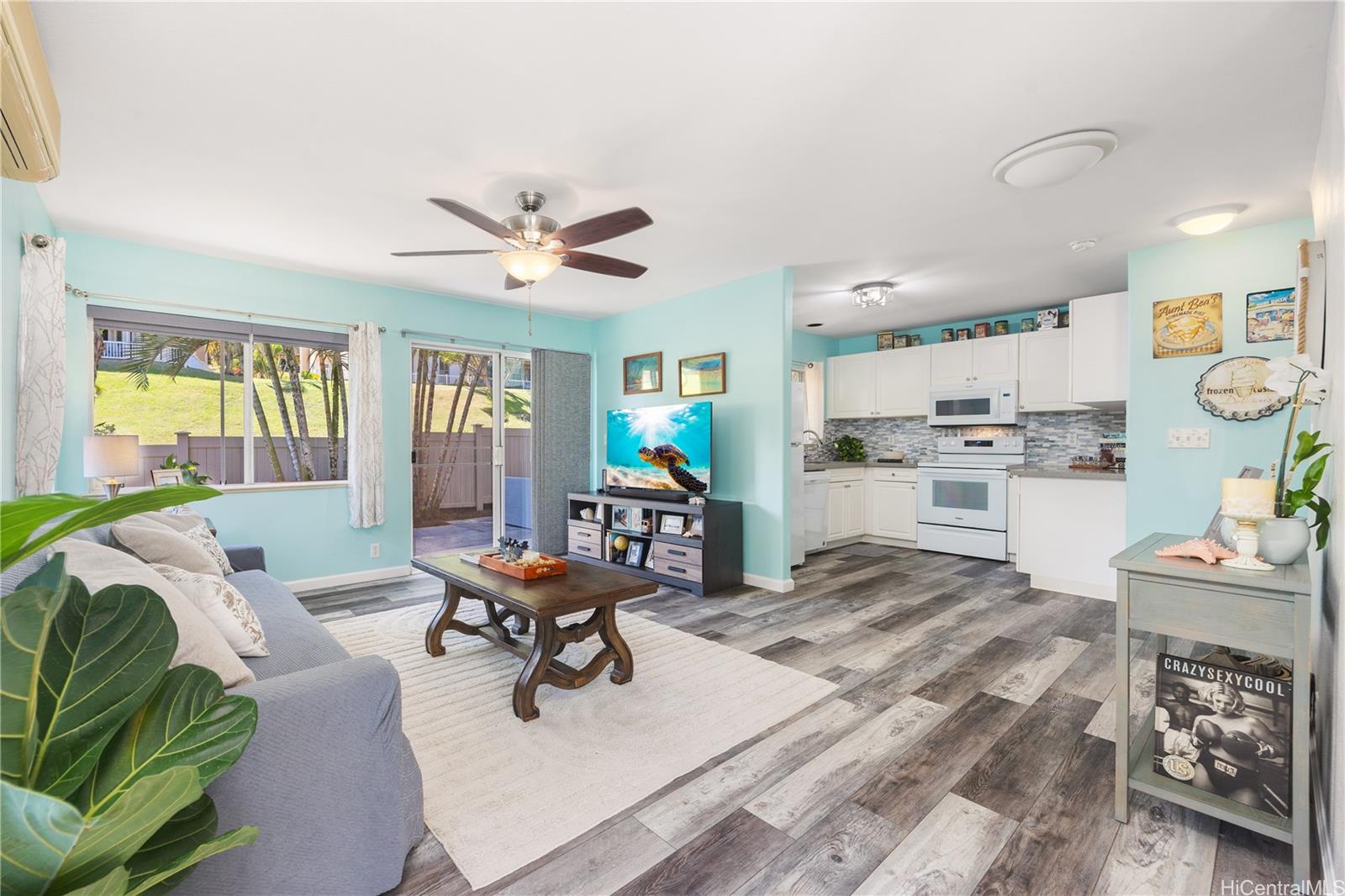 95-971 Wikao Street, Unit 11 Mililani, HI 96789 - Photo 5 of 24 a living room with furniture and a table with wooden floor