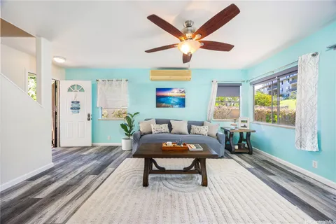 a living room with furniture a window and a table