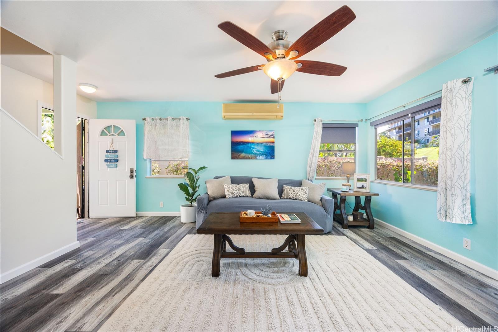 95-971 Wikao Street, Unit 11 Mililani, HI 96789 - Photo 8 of 24 a living room with furniture a window and a table