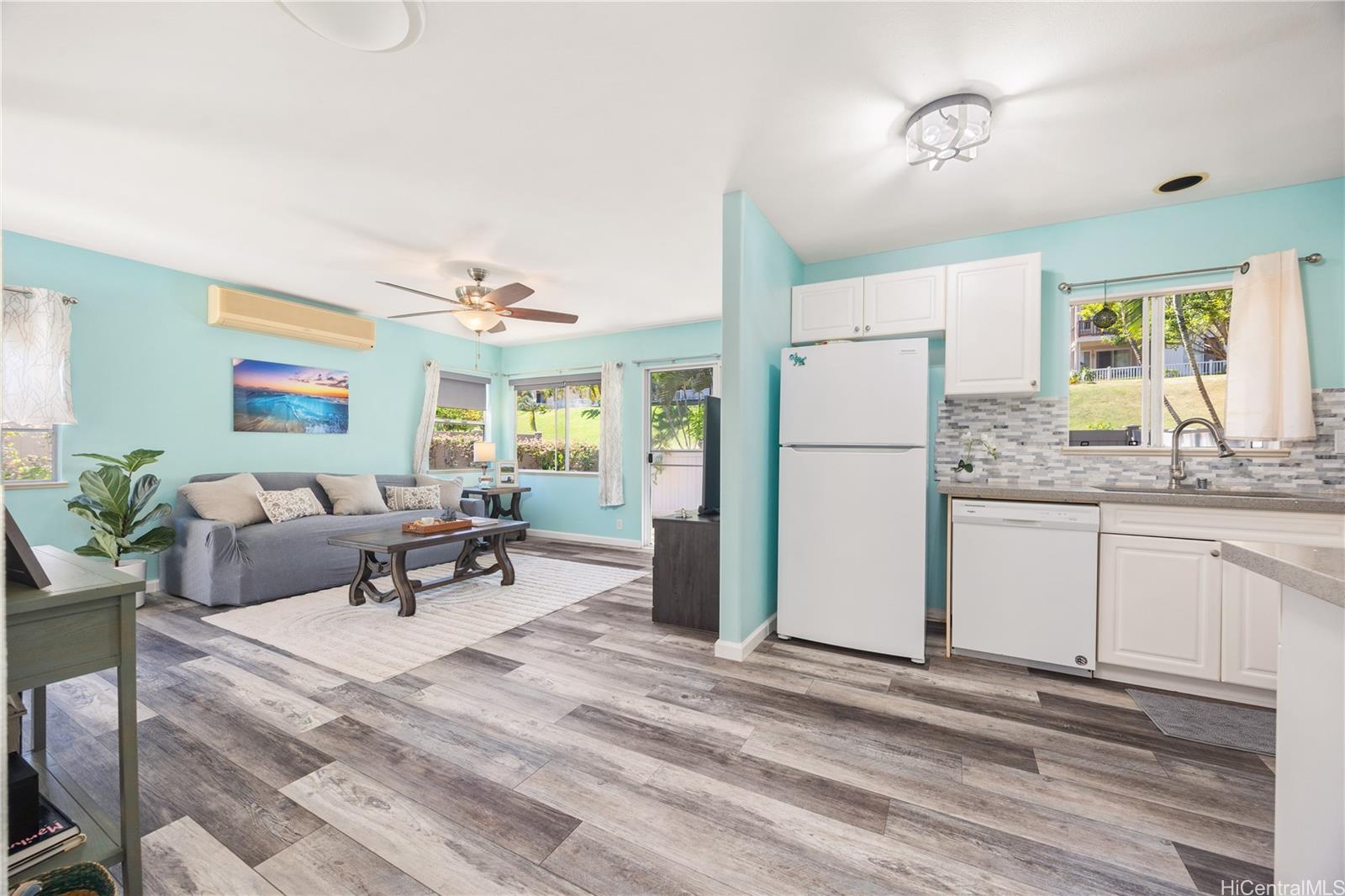 95-971 Wikao Street, Unit 11 Mililani, HI 96789 - Photo 9 of 24 a living room with furniture and a refrigerator