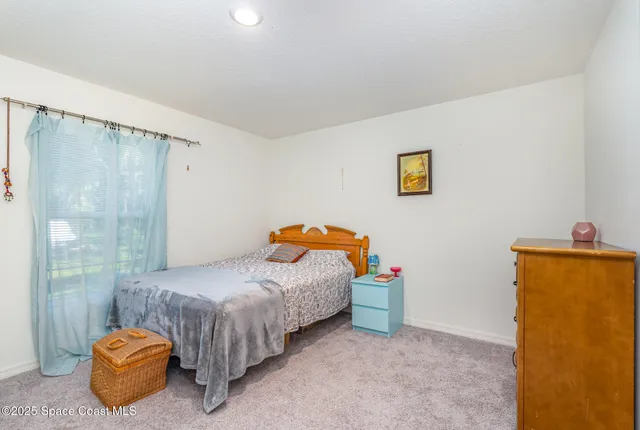 a bedroom with a bed and a table