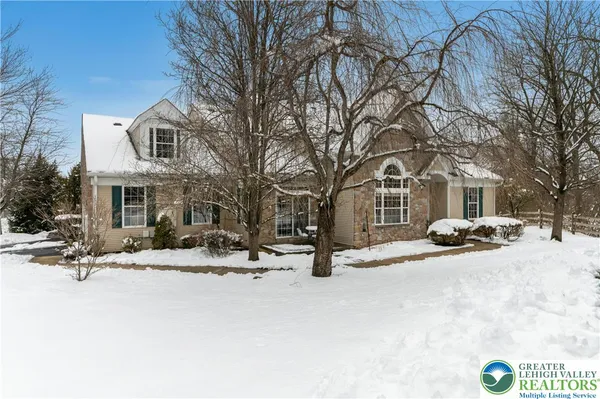 a view of a building with snow on the road