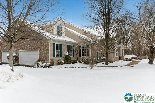 a view of a house with snow on the road