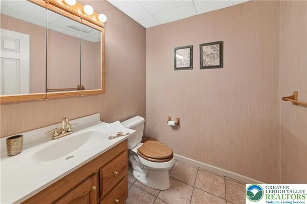 a bathroom with a sink a toilet and a mirror