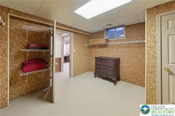 a bedroom with furniture and a mirror