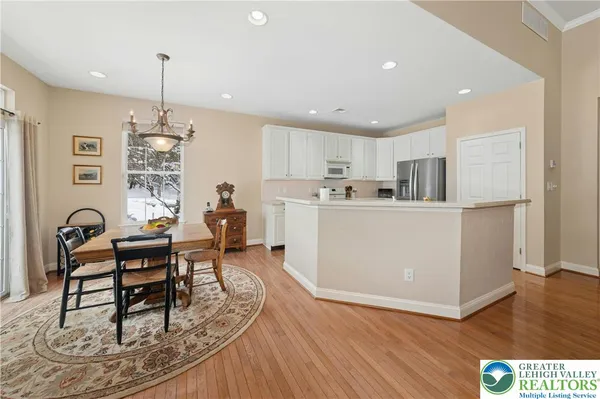 a living room with furniture a dining table and kitchen view