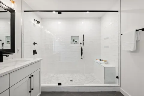 a bathroom with a shower and a sink