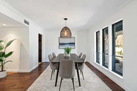 a view of a dining room with furniture window and wooden floor